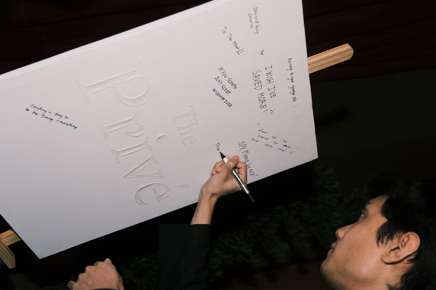 Guests writing messages at The Privé
